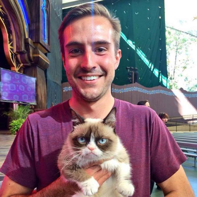 Grumpy Cat and Ridiculously Photogenic Guy at Disneyland.